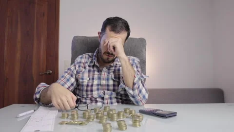 Broke man doing math takes his glasses off and shakes his head in denial. Stock Footage 269978369
