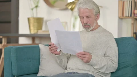 Broke Senior Old Man Checking Empty Wallet on Sofa Stock Footage 143156163