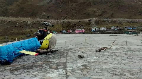 A Broken Accident Helicopter Chopper standing at Kedarnath helipad Uttarakhand Stock Footage 185703912