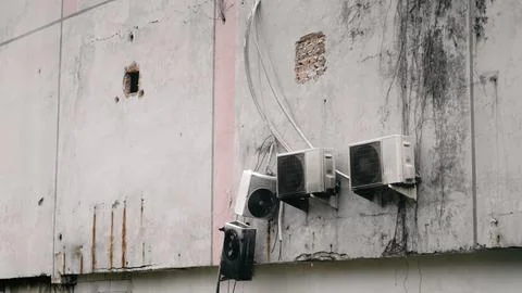 Broken Air Conditioning Units on Wall Stock Photos