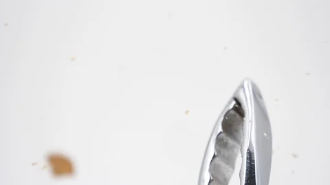 Broken almond with nutcracker on a white background, slow-motion Stock Footage 88798521