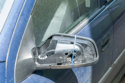 Broken and damaged side mirror on the blue car doors Stock Photos