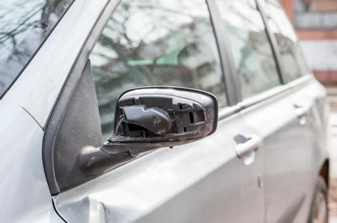 Broken and damaged side mirror on the car doors with remaining wires Stock Photos