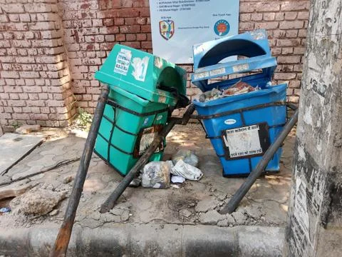 Broken and damaged trash bin made of plastic box and placed on steel pillars Stock Photos