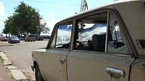 Broken and rusty car thrown on the side of the road Stock Footage 96087019