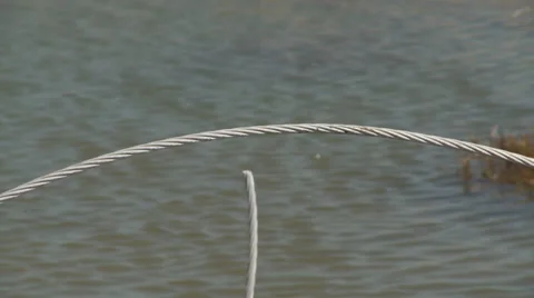 Broken and twisted power cable along a washed-out road near a beach Vídeo Stock 59548253