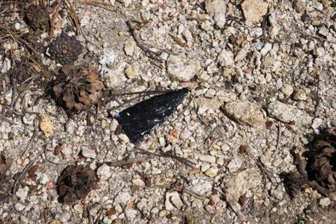 Broken arrowhead on ground Stock Photos