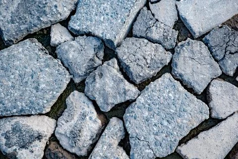 Broken asphalt creating abstract texture of destruction and decay on urban Stock Photos