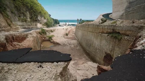 Broken asphalt road by landslide in a small canyon, south Bali Stock-Footage 65242529