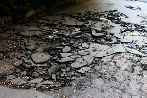 Broken asphalt on the road Stock Photos