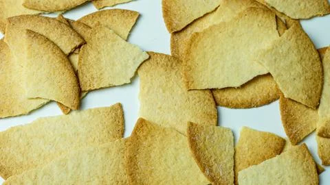 Broken baked chips crisps isolated on white background Stock Photos
