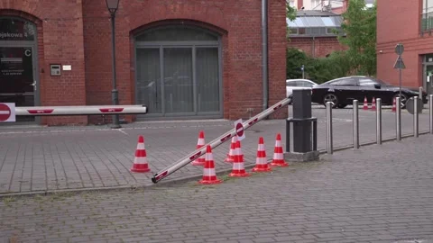 Broken barrier with traffic cones blocking the entrance Stock Footage 309010022
