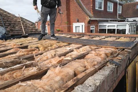 Broken beams exposed on an old flat roof extension Stock Photos