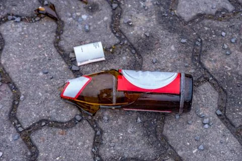 Broken beer bottles in the middle of the footpath Stock Photos