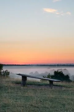 Broken bench overlooking a landscape Foto stock