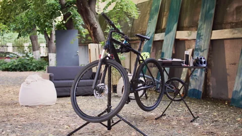Broken bicycle near toolbox outside Stock Footage 250046550