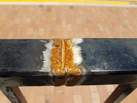 Broken black metal railing with rust and welding Stock Photos