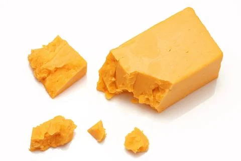 Broken Block of Orange Cheddar Cheese assorted chunks pieces bits Stock Photos