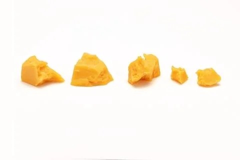 Broken Block of Orange Cheddar Cheese assorted chunks pieces bits Stock Photos