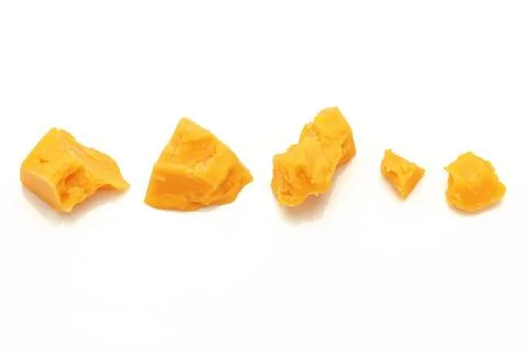 Broken Block of Orange Cheddar Cheese assorted chunks pieces bits Stock Photos