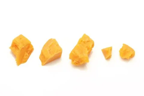Broken Block of Orange Cheddar Cheese assorted chunks pieces bits Stock Photos