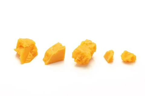 Broken Block of Orange Cheddar Cheese assorted chunks pieces bits Stock Photos
