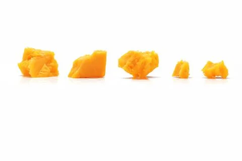 Broken Block of Orange Cheddar Cheese assorted chunks pieces bits Stock Photos