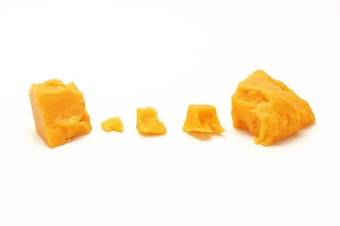 Broken Block of Orange Cheddar Cheese assorted chunks pieces bits Stock Photos