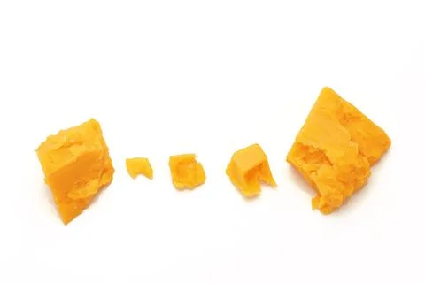 Broken Block of Orange Cheddar Cheese assorted chunks pieces bits Stock Photos