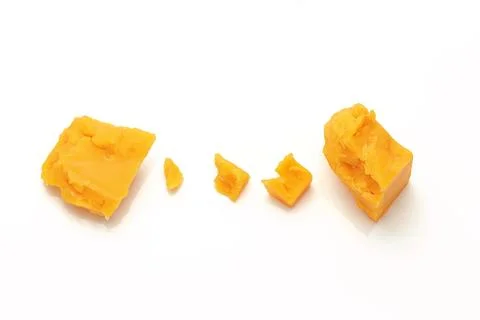 Broken Block of Orange Cheddar Cheese assorted chunks pieces bits Stock Photos