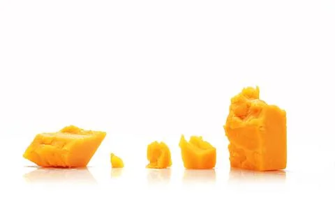 Broken Block of Orange Cheddar Cheese assorted chunks pieces bits Stock Photos