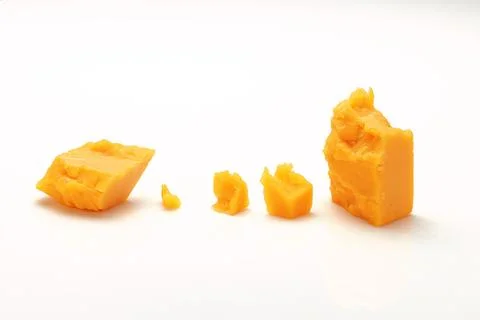 Broken Block of Orange Cheddar Cheese assorted chunks pieces bits Stock Photos