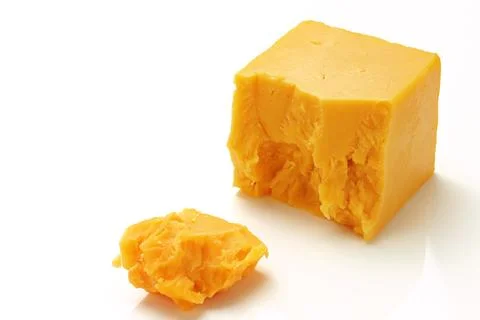 Broken Block of Orange Cheddar Cheese assorted chunks pieces bits Stock Photos