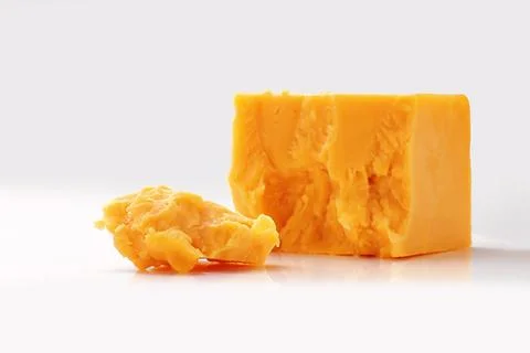 Broken Block of Orange Cheddar Cheese assorted chunks pieces bits Stock Photos