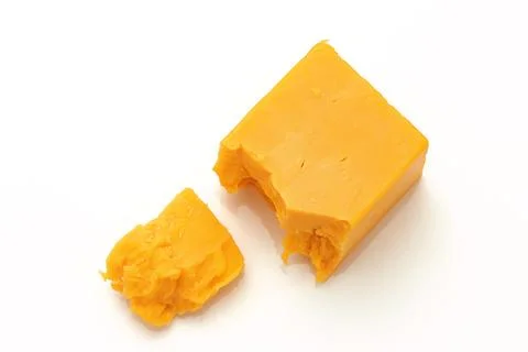 Broken Block of Orange Cheddar Cheese assorted chunks pieces bits Stock Photos