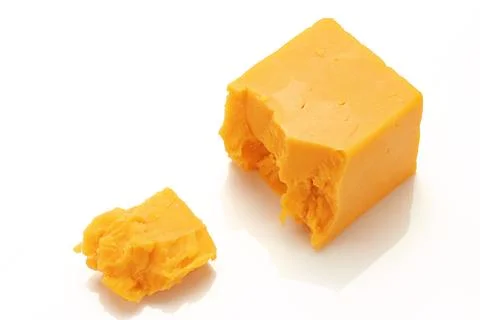 Broken Block of Orange Cheddar Cheese assorted chunks pieces bits Stock Photos