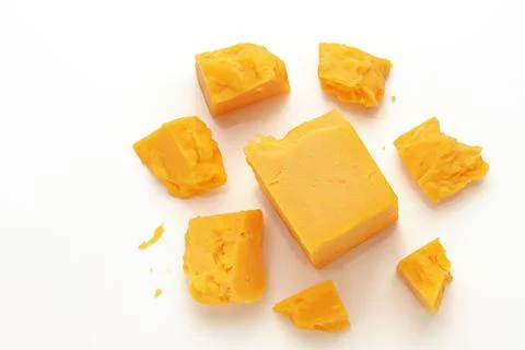Broken Block of Orange Cheddar Cheese assorted chunks pieces bits Stock Photos