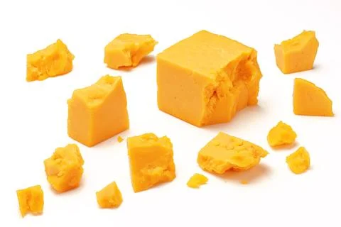 Broken Block of Orange Cheddar Cheese assorted chunks pieces bits Stock Photos