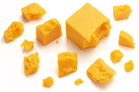 Broken Block of Orange Cheddar Cheese assorted chunks pieces bits Stock Photos