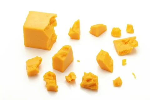 Broken Block of Orange Cheddar Cheese assorted chunks pieces bits Stock Photos