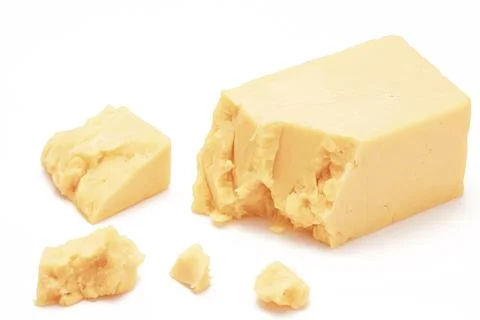 Broken Block of White Cheddar Cheese assorted chunks pieces bits Stock Photos