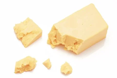 Broken Block of White Cheddar Cheese assorted chunks pieces bits Stock Photos