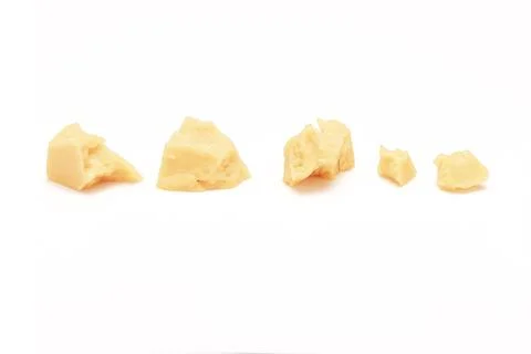 Broken Block of White Cheddar Cheese assorted chunks pieces bits Stock Photos