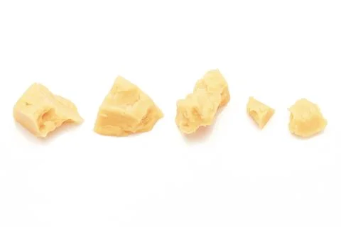 Broken Block of White Cheddar Cheese assorted chunks pieces bits Stock Photos