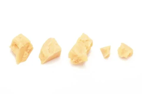 Broken Block of White Cheddar Cheese assorted chunks pieces bits Stock Photos