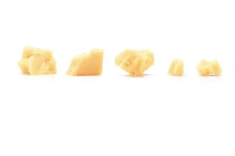 Broken Block of White Cheddar Cheese assorted chunks pieces bits Stock Photos