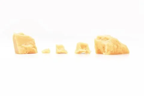 Broken Block of White Cheddar Cheese assorted chunks pieces bits Stock Photos