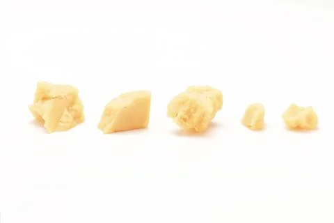 Broken Block of White Cheddar Cheese assorted chunks pieces bits Stock Photos
