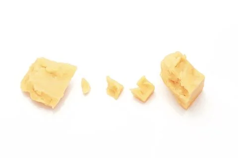 Broken Block of White Cheddar Cheese assorted chunks pieces bits Stock Photos
