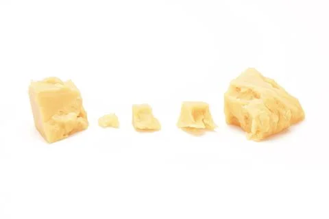 Broken Block of White Cheddar Cheese assorted chunks pieces bits Stock Photos